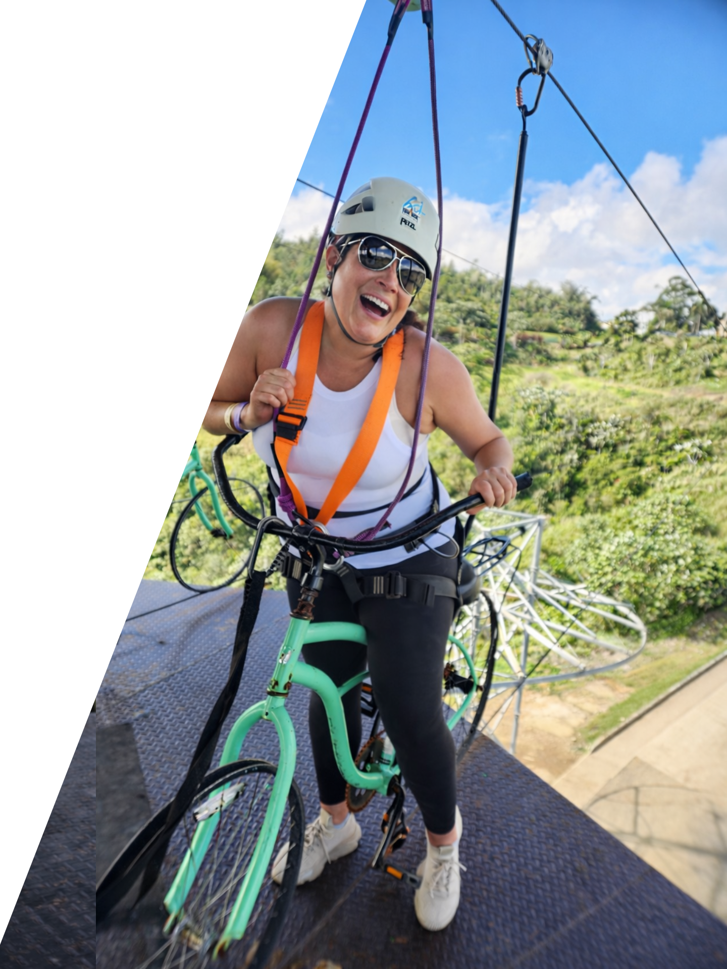 Group of people riding black ATVs on a gravel trail.